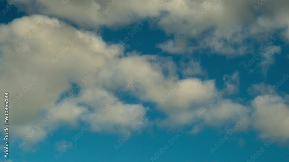 Blue sky background time lapse white clouds. Abstract flowing puffy clouds in the air. High solar cumulus cloud. Blue sky background time lapse white clouds. Abstract flowing puffy clouds in the air. High solar cumulus cloud.