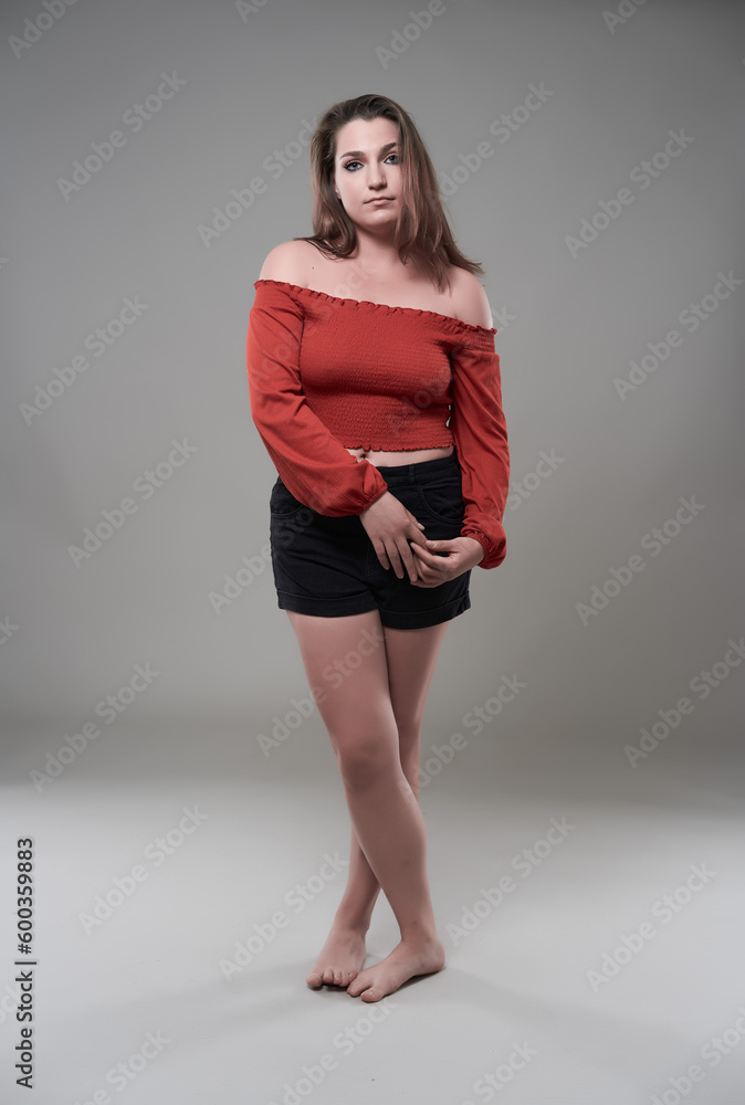 Confident plus size woman on gray background Confident plus size woman on gray background