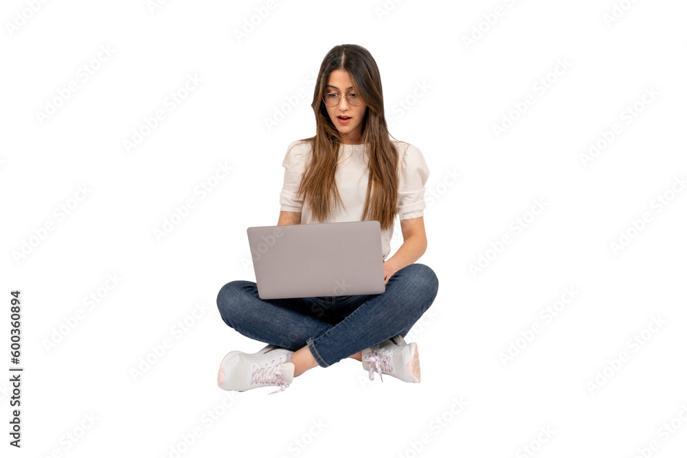 Shocked young woman, full body shot of shocked young woman. Sitting on the floor, using laptop. Lifestyle concept. Holding notebook. Surprised by what she saw on the social media. Copy space. Shocked young woman, full body shot of shocked young woman. Sitting on the floor, using laptop. Lifestyle concept. Holding notebook. Surprised by what she saw on the social media. Copy space.