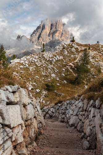 Trail at Cinque Torri leading through trenches from the First World War. Spectacular view of Tofana di Rozes mountain. WW 1 Open Air Museum at 5 Torri, Dolomiti Ampezzane, Veneto, Dolomites, Italy. photo