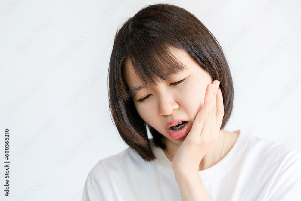 Woman holding her cheek due to toothache. Woman holding her cheek due to toothache.