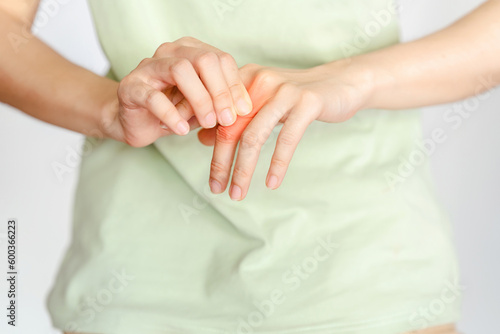 Woman finger joint pain due to arthritis. Concept of health problems.