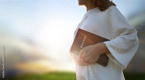 Christian background and worship and evangelism concept with church hand holding holy bible and preaching the gospel of jesus christ
 photo