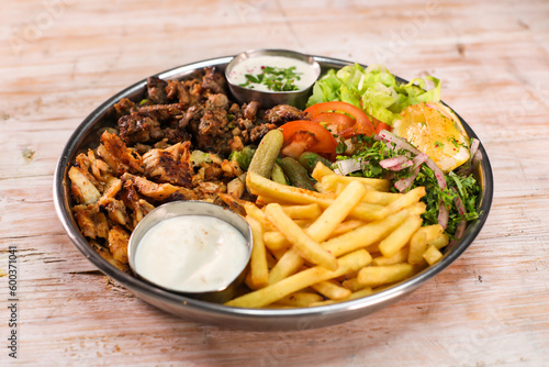 Mix Laham, beef, chicken, dajaj shawarma platter with fries and salad served in dish isolated on table top view fastfood