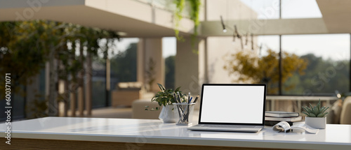 Home workspace with laptop mockup on white table in modern contemporary living room