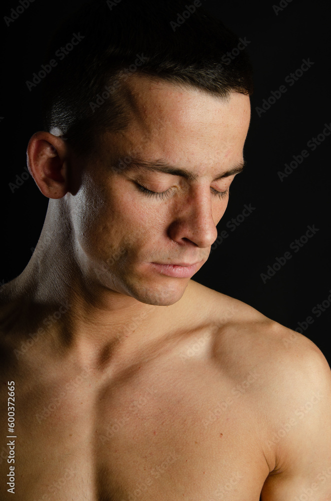Young attractive man posing in the studio. Young attractive man posing in the studio.
