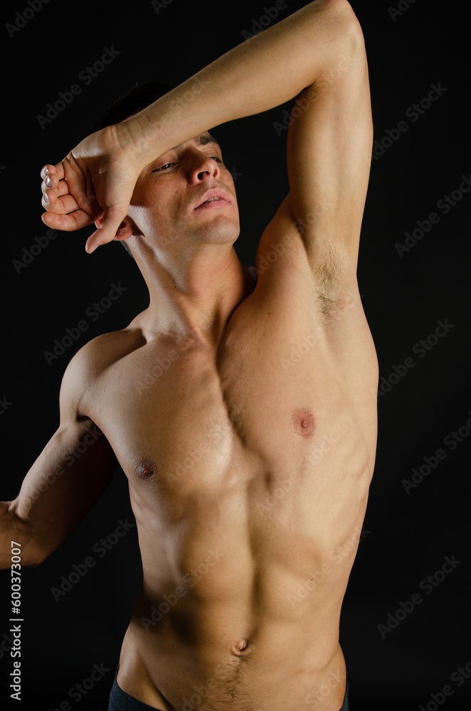 Young attractive man posing in the studio. Young attractive man posing in the studio.