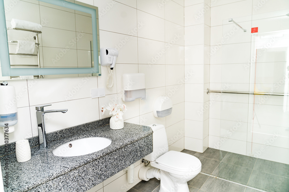 Clean light bathroom. White sink with mirror interior bathroom. Clean light bathroom. White sink with mirror interior bathroom.