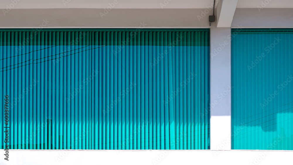 Obraz premium Blue Aluminium venetian blinds behind glass wall inside of white office building 