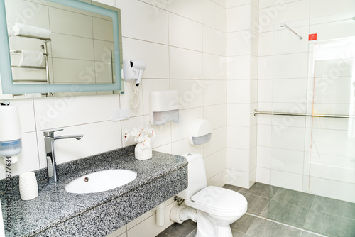 Clean light bathroom. White sink with mirror interior bathroom.