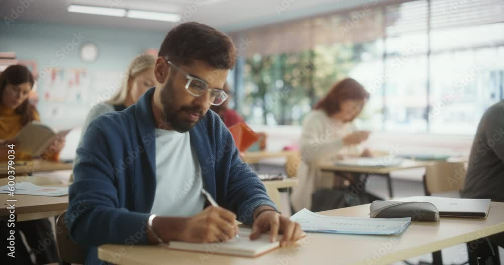 Multiethnic Indian Man Acquiring New Academic Skills in Classroom with Other People. Formal Adult Learning Activity, Undertaken by Diverse Mature Students After Finishing School and College Multiethnic Indian Man Acquiring New Academic Skills in Classroom with Other People. Formal Adult Learning Activity, Undertaken by Diverse Mature Students After Finishing School and College