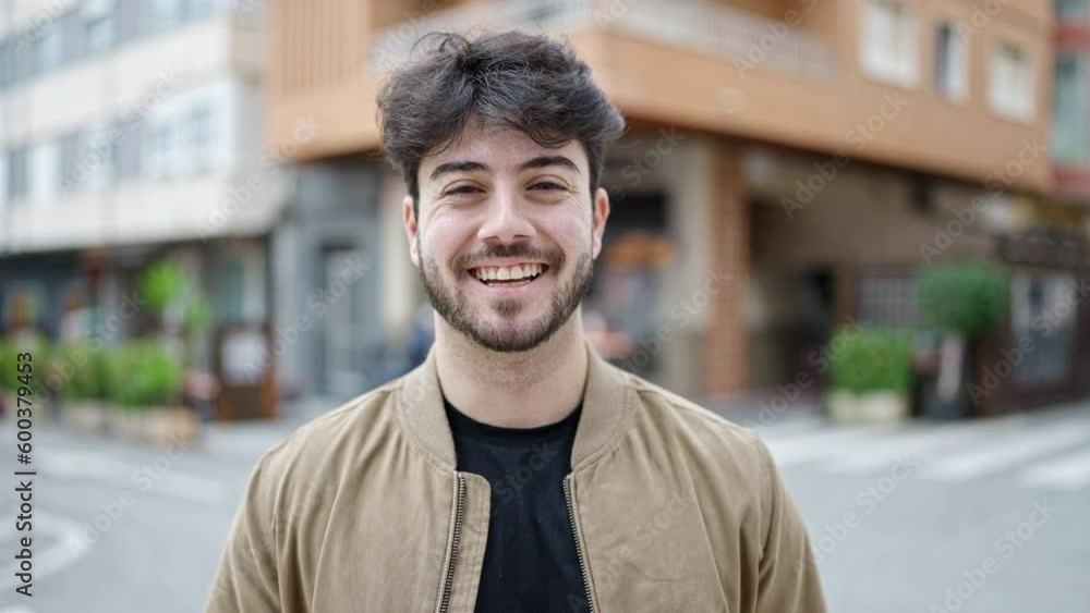 Young hispanic man smiling confident standing at coffee shop terrace Young hispanic man smiling confident standing at coffee shop terrace