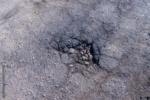 a damaged paved road with a lot of holes