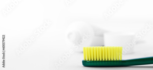 Toothbrush on the background of an open tube of toothpaste. Oral Care Concept.
