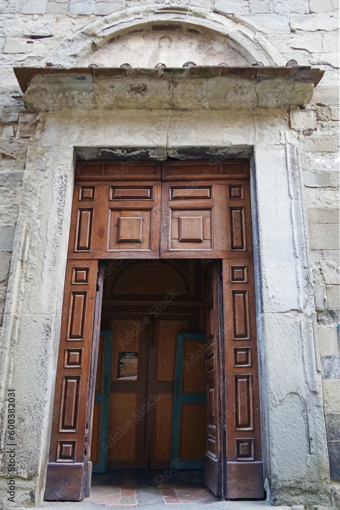 Entrance door to the parish church of San Bartolomeo in the medieval old town of Anghiari, Tuscany, Italy