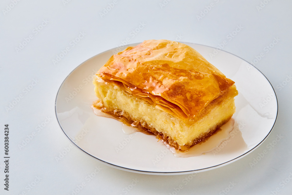 piece of galaktoboureko on a white plate piece of galaktoboureko on a white plate