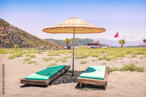 Fototapeta Naklejka Na Ścianę i Meble -  Sunbeds and umbrellas on Iztuzu Beach, Turtle Beach, Dalyan River, Mediterranean Sea, Marmaris, Turkey