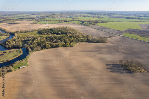 Beautiful aerial view of the fields and nature, curved river and big trees. Agriculture in Sweden, ecology.