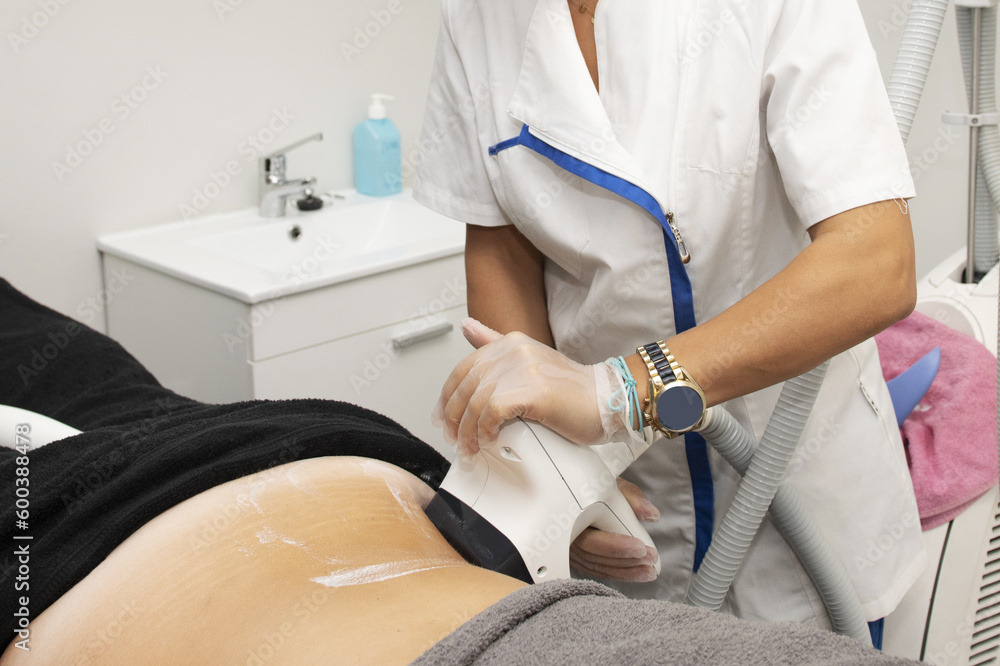 An operation from a bea An operation at a beauty center applied treatments to the back of a patient lying on a table An operation from a bea An operation at a beauty center applied treatments to the back of a patient lying on a table