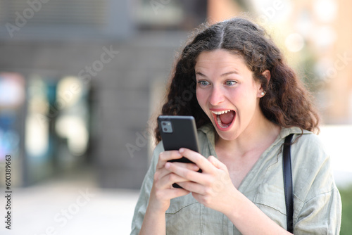 Excited woman watching amazing content on phone