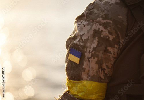 the Ukrainian flag in the form of a chevron on the hand of a military man © alimyakubov