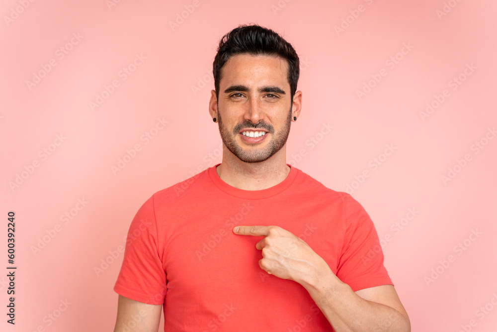 Man pointing to the side in a studio shot. Man pointing to the side in a studio shot.