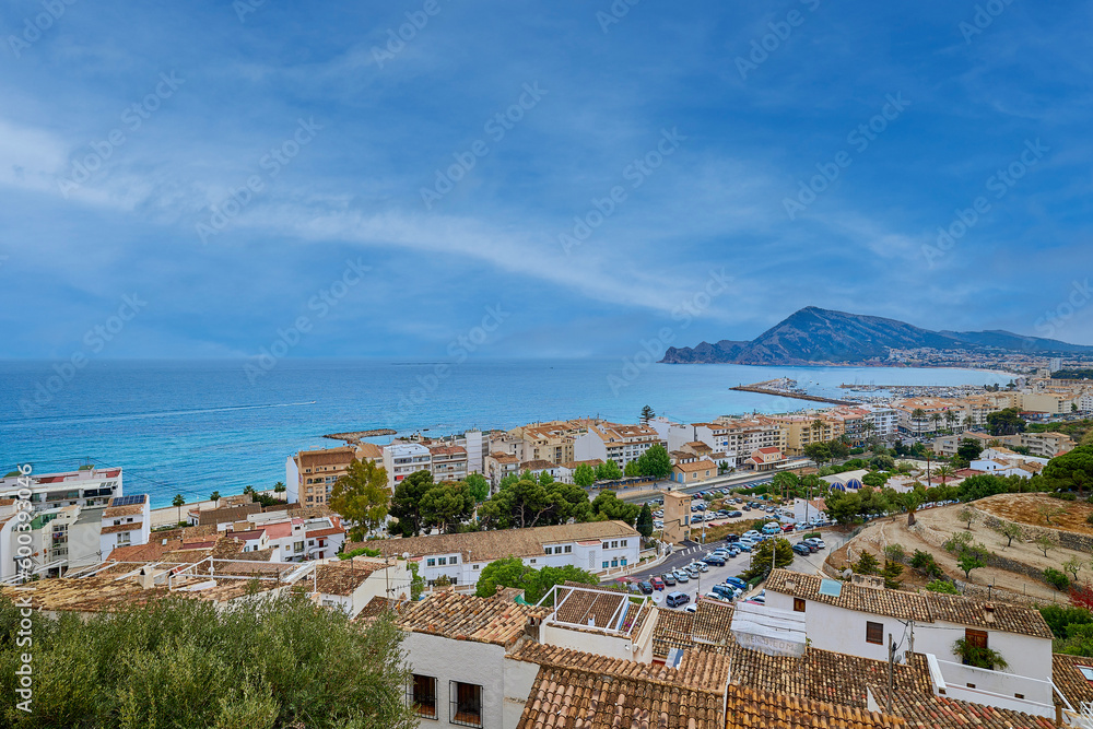A small old town on the Mediterranean coast. View of the rooftops and the sea from a high point.