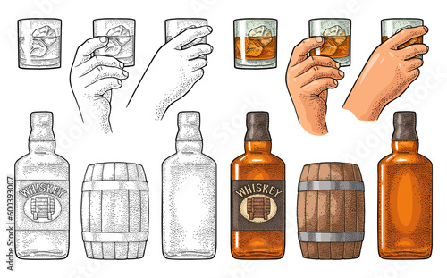 Whiskey glass with ice cubes, barrel, bottle