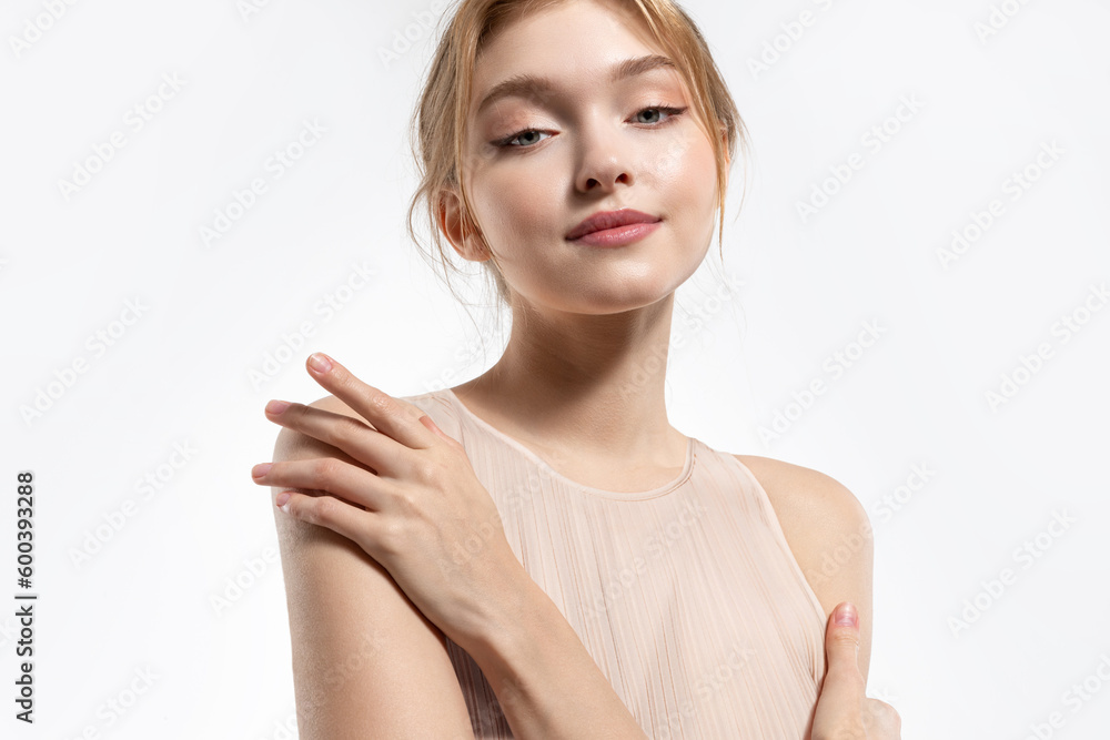 A beautiful blonde young woman with glowing skin and a sweet smile wearing a soft pink dress A beautiful blonde young woman with glowing skin and a sweet smile wearing a soft pink dress