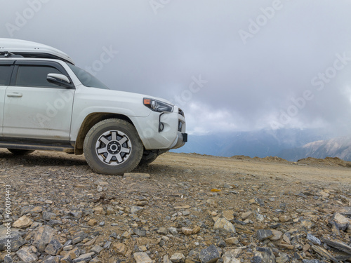 Driving car on high altitude mountain trail, China