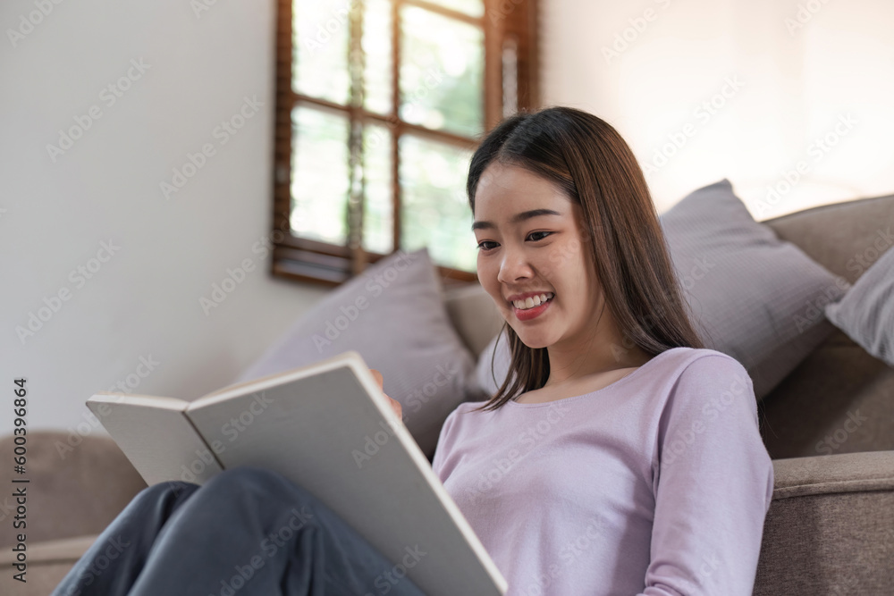 Attractive young Asian woman sleep in the minimal and comfortable living room enjoying reading a book Attractive young Asian woman sleep in the minimal and comfortable living room enjoying reading a book