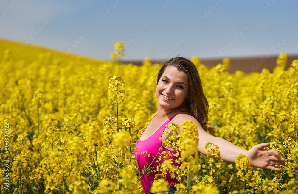 Beautiful woman with blue eyes in a canola field Beautiful woman with blue eyes in a canola field
