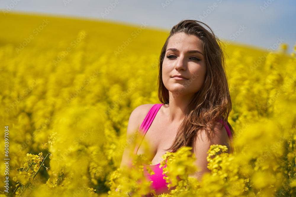 Beautiful woman with blue eyes in a canola field Beautiful woman with blue eyes in a canola field