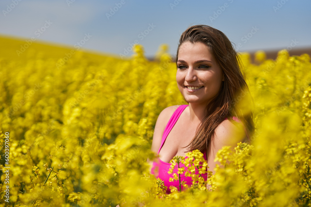 Beautiful woman with blue eyes in a canola field Beautiful woman with blue eyes in a canola field