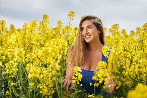 Attractive blonde latino woman in canola field