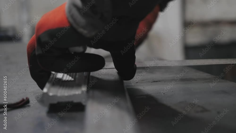 The worker doing the measurement for metal cutting The worker doing the measurement for metal cutting