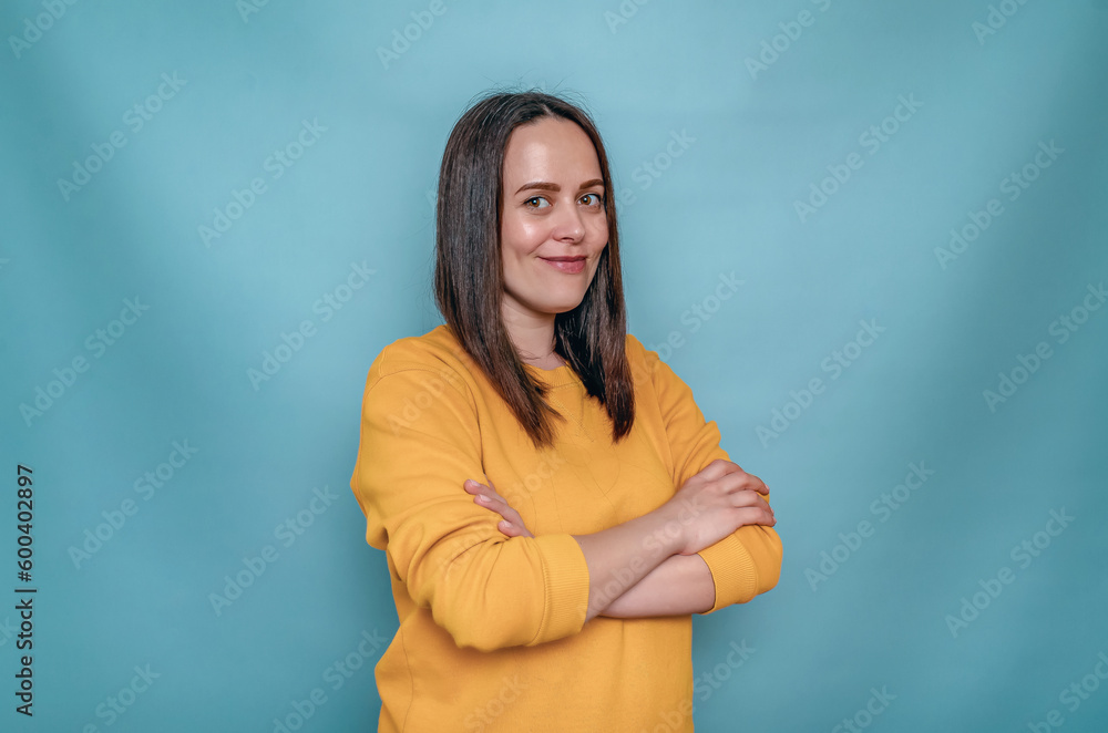 Side view of smiling stylish woman with dark hair. Intertwined hands. Yellow sweater. Side view of smiling stylish woman with dark hair. Intertwined hands. Yellow sweater.
