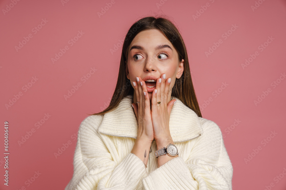 Shocked woman standing with her mouth opened isolated over pink background Shocked woman standing with her mouth opened isolated over pink background