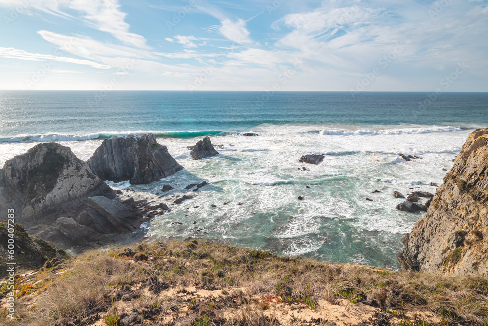 Typical scenery on the Atlantic coast. High rocky cliffs with sandy beaches in Odemira region, western Portugal. Wandering along the Fisherman Trail, Rota Vicentina Typical scenery on the Atlantic coast. High rocky cliffs with sandy beaches in Odemira region, western Portugal. Wandering along the Fisherman Trail, Rota Vicentina
