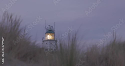 Red Brick Structure Of Vuurtoren Westhoofd Lighthouse In Ouddorp, Netherlands. narrow Shot with dunes and dune grass in front. High quality 4k footage photo