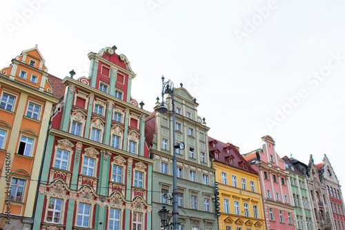 City view of the old buildings with colorful walls, decorative elements on the facades and lantern. Central square, old market with historical buildings. Old town. Poland, Wroclaw, January 2023.