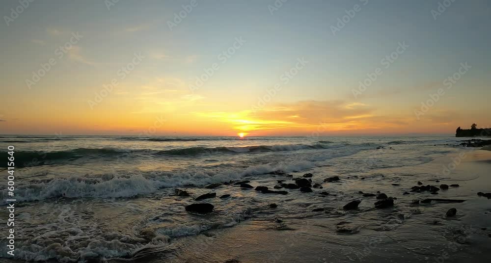Sunset over the rocky beach with sea waves Sunset over the rocky beach with sea waves