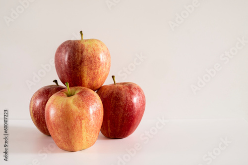 Three fresh red apples on a white background.