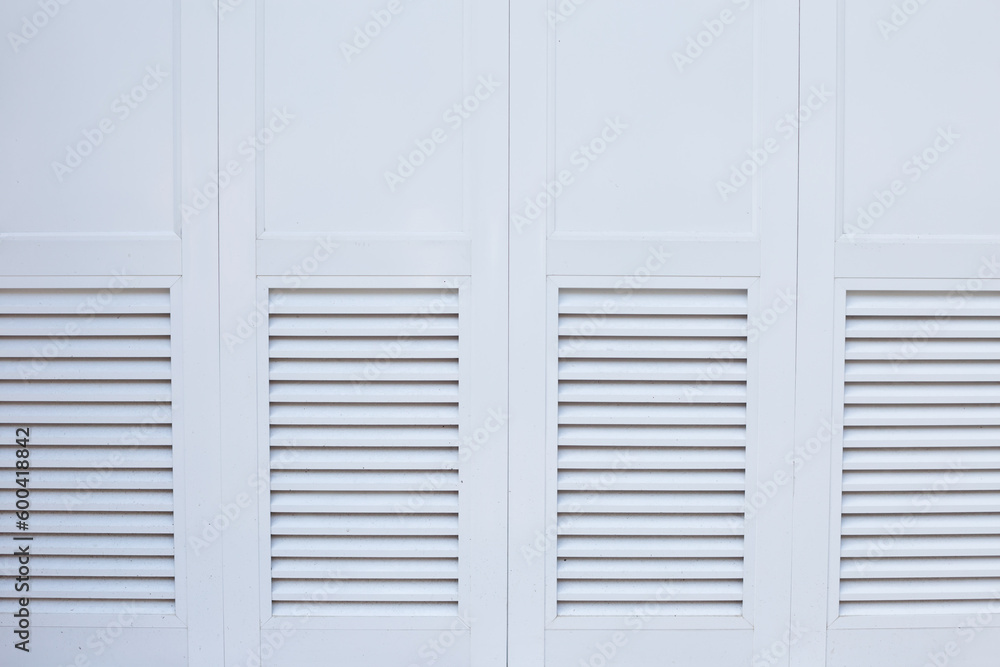 Closed white doors. Natural wooden background with space for text Closed white doors. Natural wooden background with space for text
