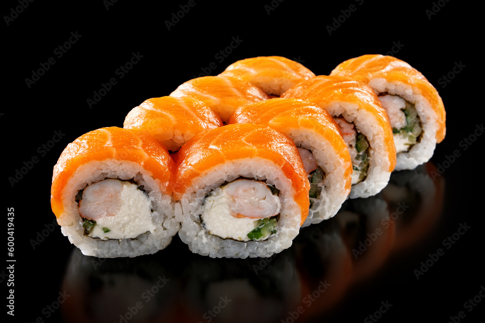 Closeup fresh Sushi Rolls with shrimp, cucumber and cheese philadelphia isolated on black background Closeup fresh Sushi Rolls with shrimp, cucumber and cheese philadelphia isolated on black background