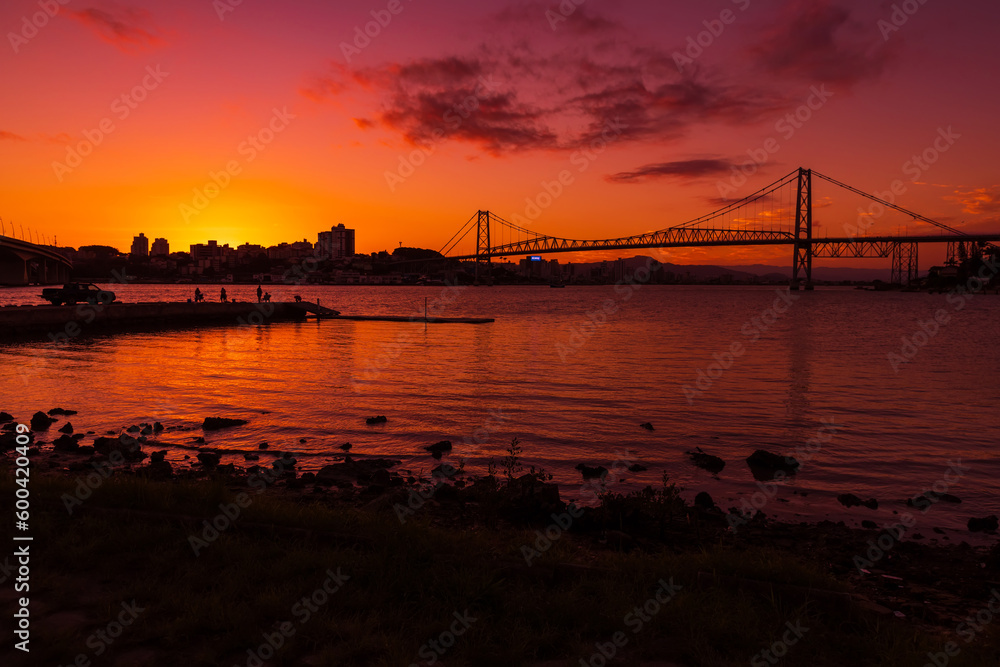Hercilio luz cable bridge with sunset sky and reflection on water in Florianopolis, Brazil