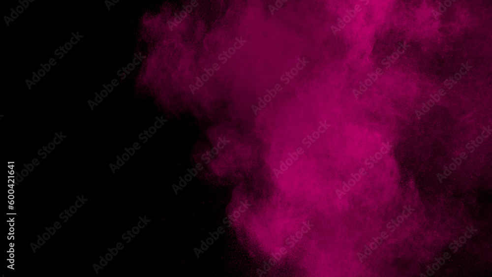 pink smoke thrown into the air on black background