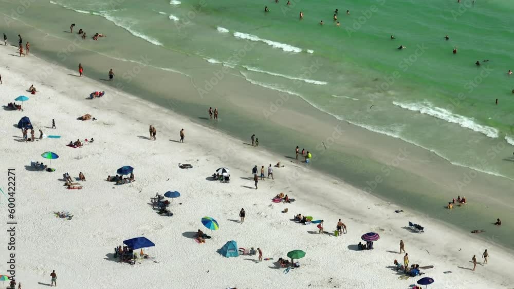 Aerial view of Siesta Key beach in Sarasota, USA. Many people enjoing vacation time swimming in gulf water and relaxing on warm Florida sun Aerial view of Siesta Key beach in Sarasota, USA. Many people enjoing vacation time swimming in gulf water and relaxing on warm Florida sun