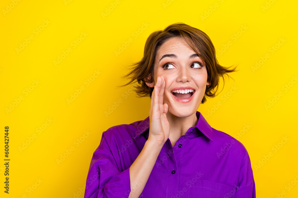Photo of nice cheerful person hand near mouth communicate look empty space isolated on yellow color background - obrazy, fototapety, plakaty 