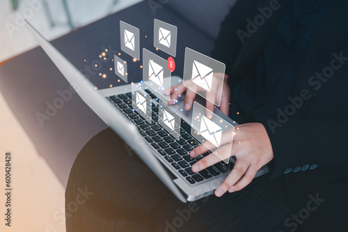 Businessman using a laptop with email notification concept for marketing and newsletter concept, Digital communication with email messages, Sending and receiving messages online with the email icon